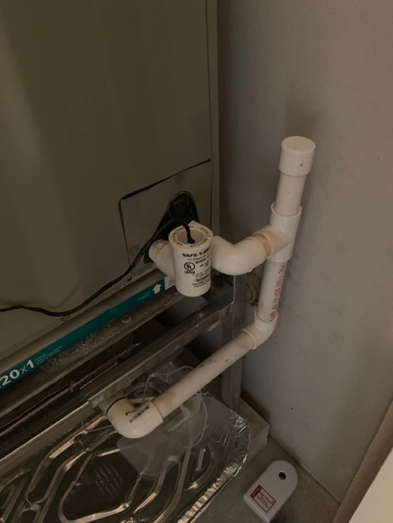 Pipe with auto shut-off switch on left (cap with black wire), can be lifted off to pour Nu Line into pipe, which will flow into the A/C condensation pan at the bottom of the Air Handler, and out through the pipe to the right. The pipe to the right has a lift -off cap to pour either vinegar or Nu Line to clean out the horizontal a/c condensation drainpipe.