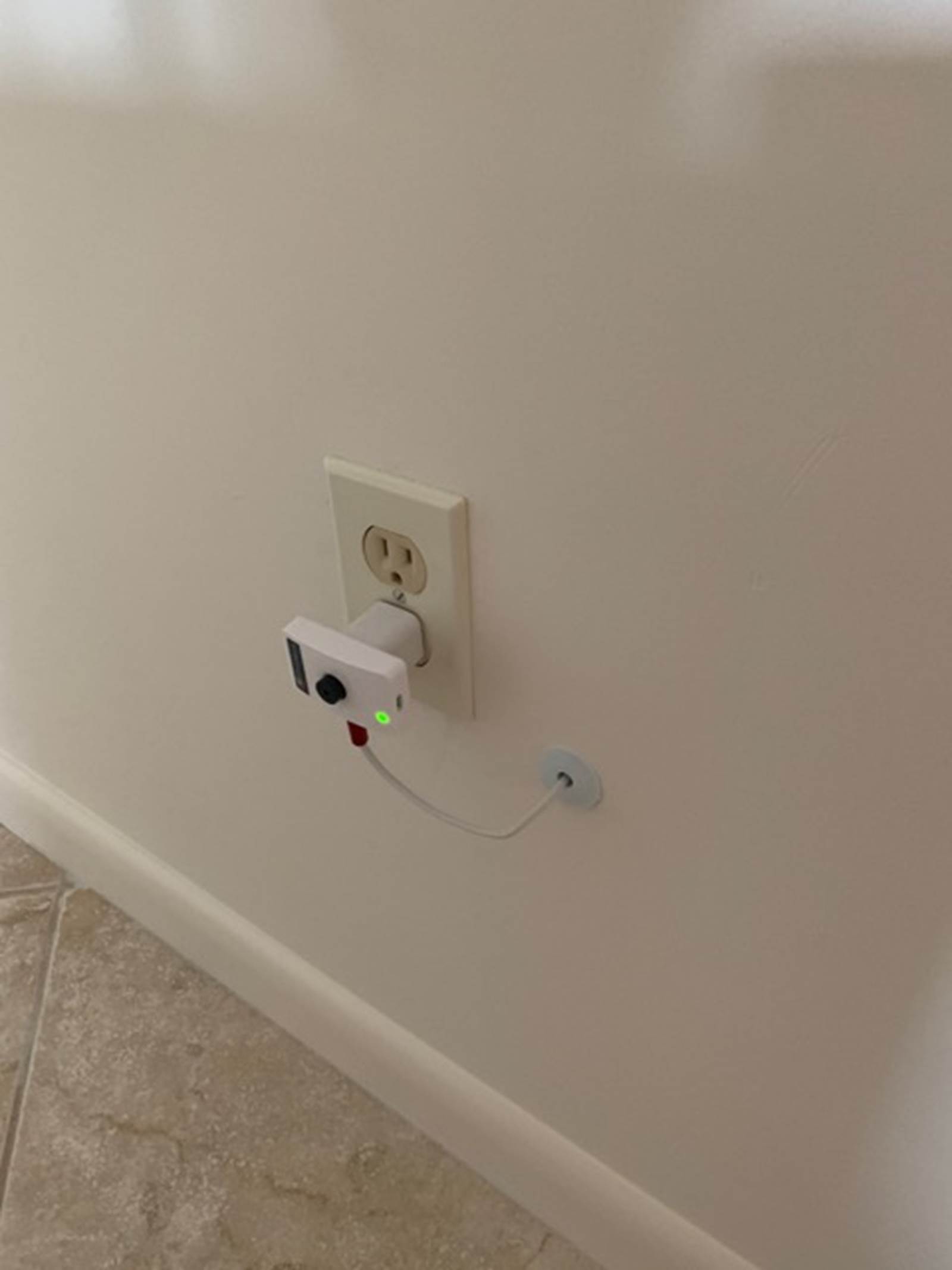 The Proteus Wi-Fi sensor water alarm, plugged into the socket outside of the air handler closet with wire through wall and sensor placed under the air handler (not shown).